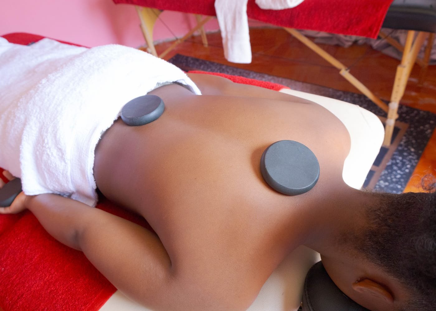Warm stones placed along the spine during a hot stone massage