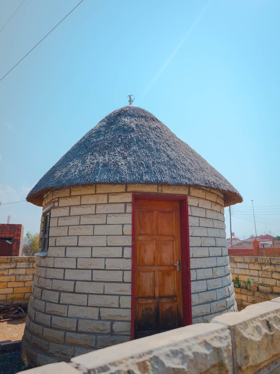 Thatched sandstone rondavel treatment rooms in Hlotse