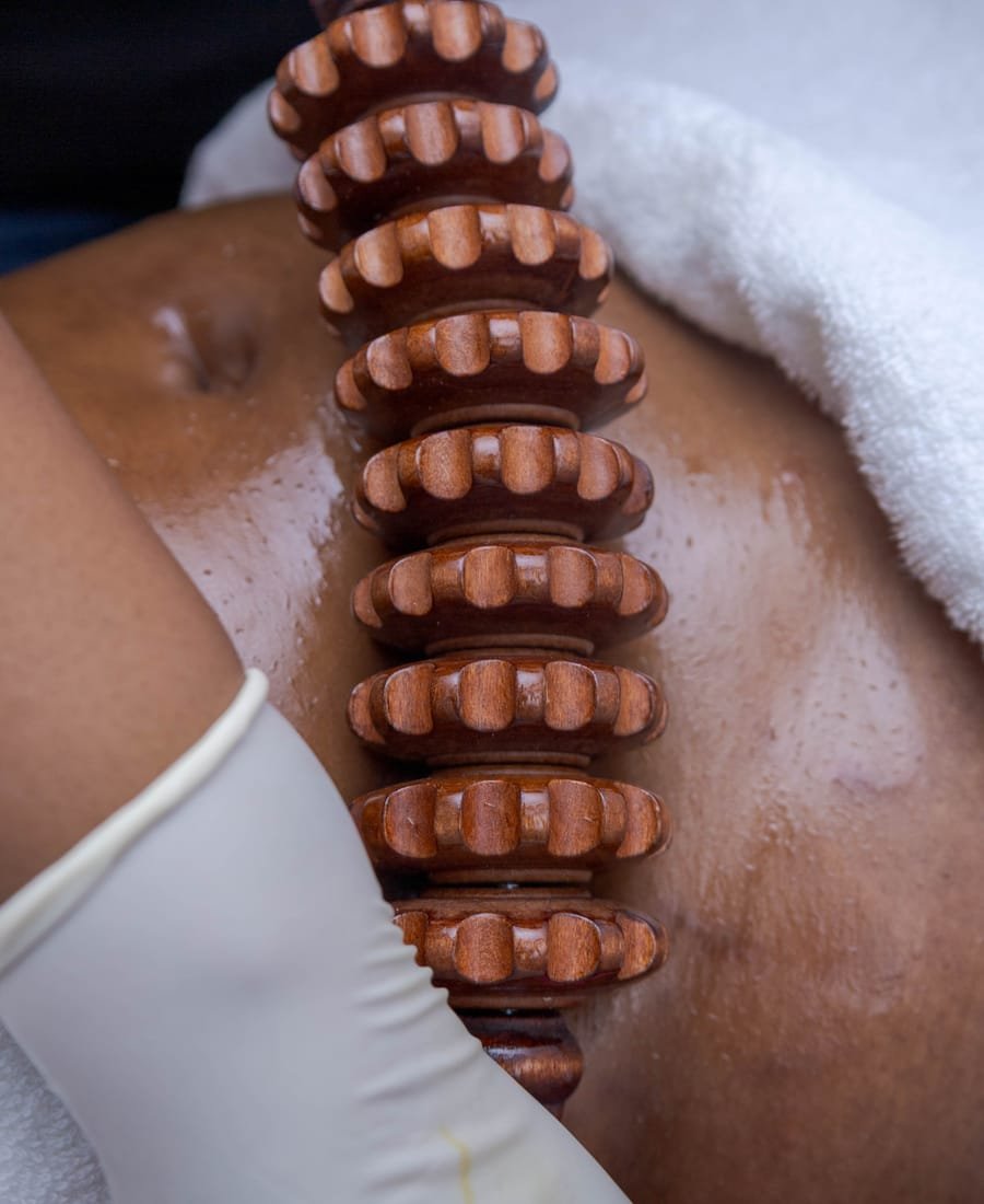 Wood therapy body sculpting with wooden rollers